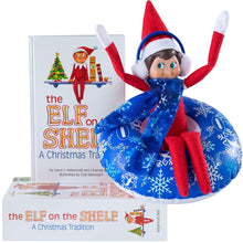 Load image into Gallery viewer, Elf On The Shelf Boy with Snow Tube Set - Blue Eyed Boy Elf Doll with Book and Winter Ski Gear - Tube, Scarf and Earmuffs- Customize Your Elf for Wintertime Adventures